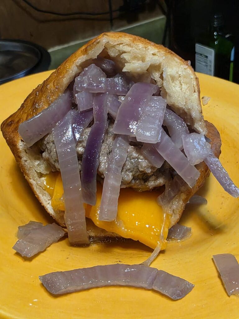 Boiled burger with onions and cheddar in fry bread