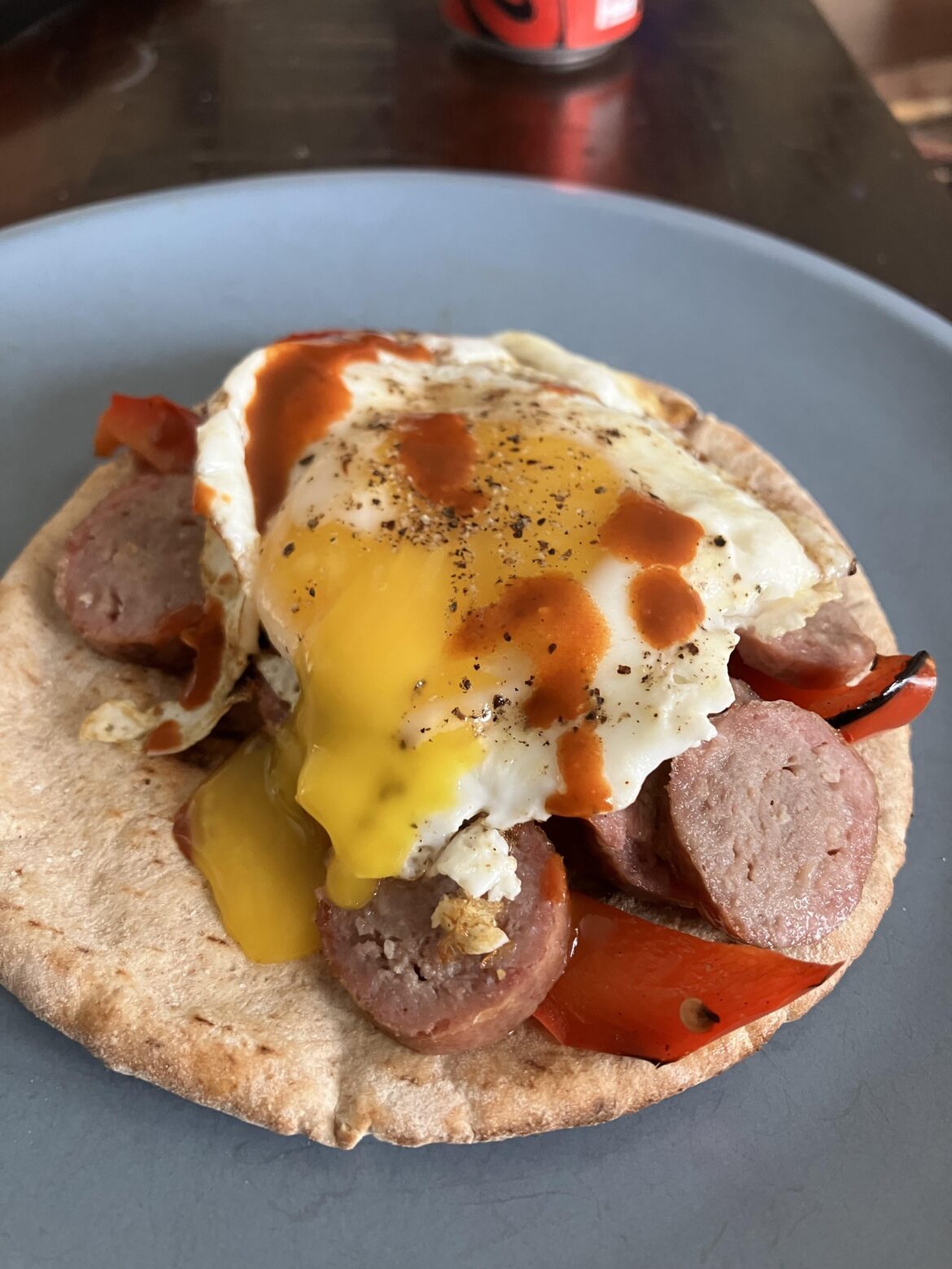I improved the Polish sausage and grilled peppers from last night by adding it to a pita with an egg and hot sauce