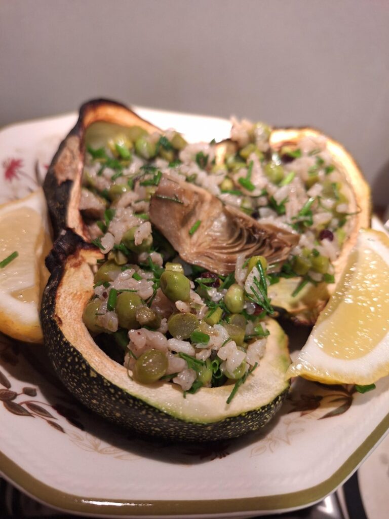 Spring rice with asparagus, artichoke and peas in zucchini bowls