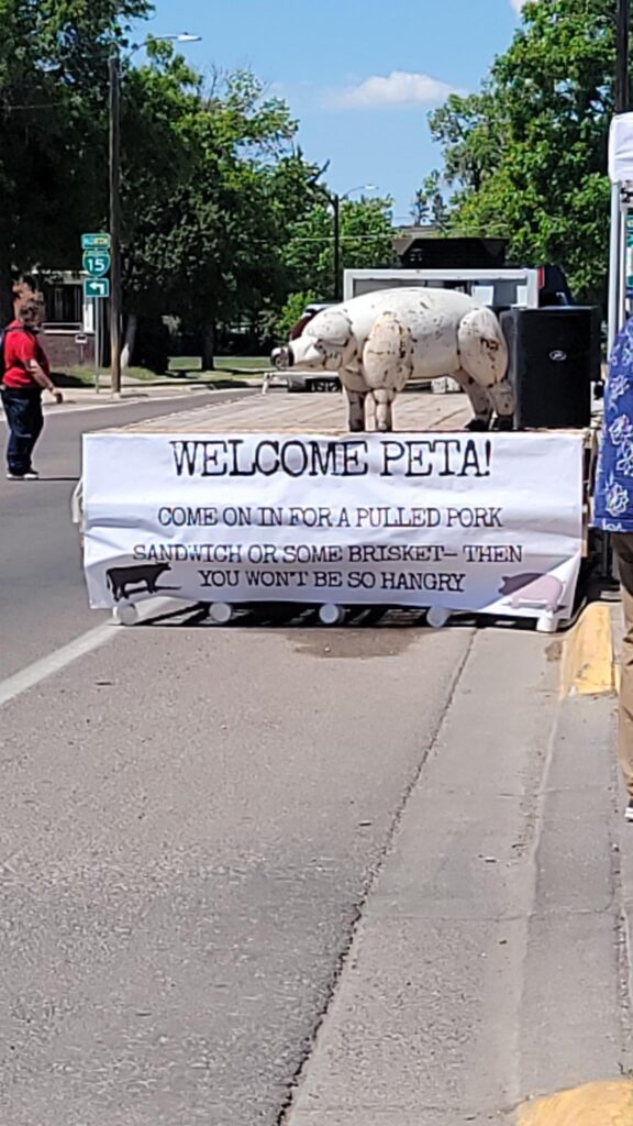 PETA is in town to protest animal cruelty by parking a truck with pictures of pigs in cages and speakers that play sounds of pigs squealing outside one of our BBQ joints. Someone pulled up in front with a big 5th wheel and a sign for them, so they couldn't park in front of the restaurant.