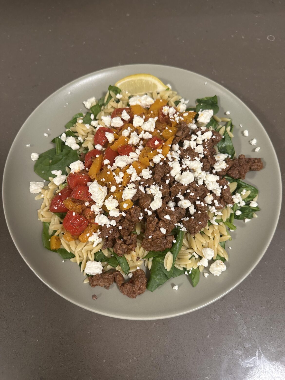 Lemony beef and orzo bowls with feta and sweet peppers.