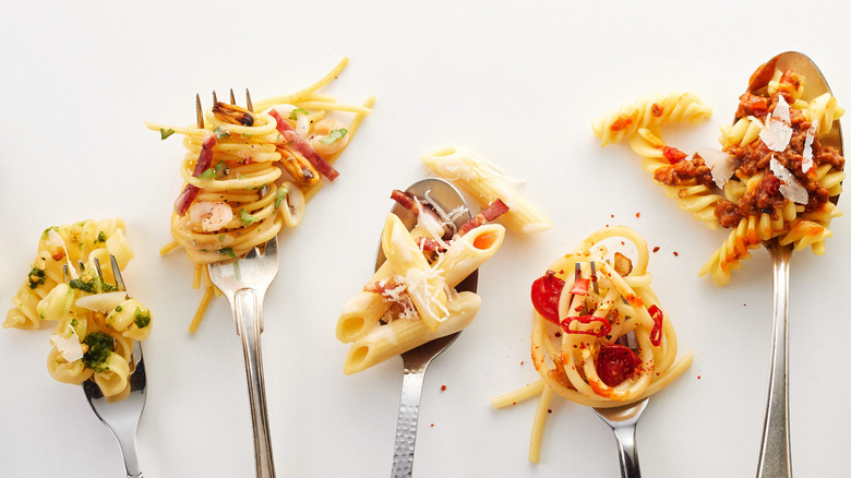 various pastas on utensils