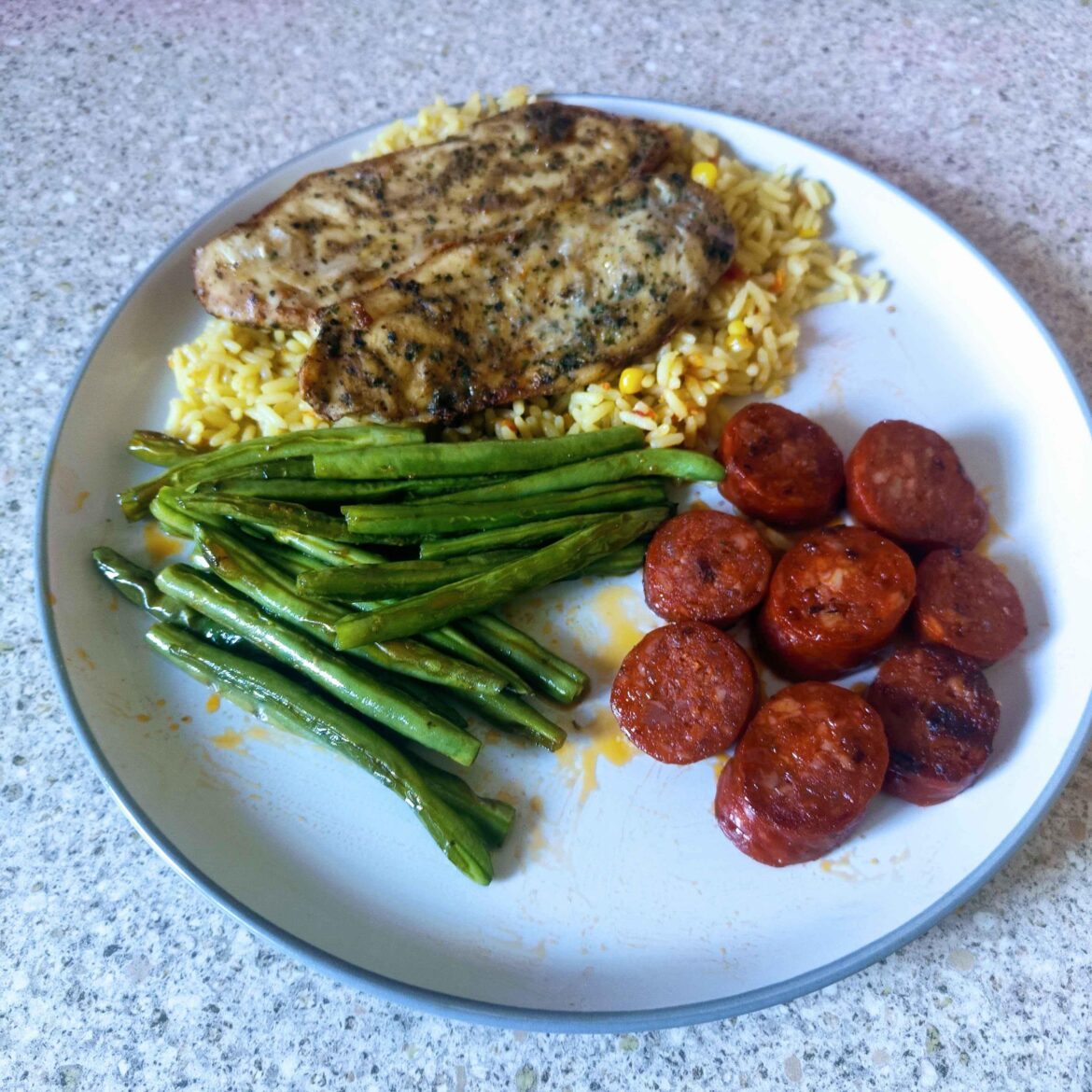 Grilled garlic and herb chicken over golden vegetable rice with home grown green beans pan fried in the oils of homemade chorizo