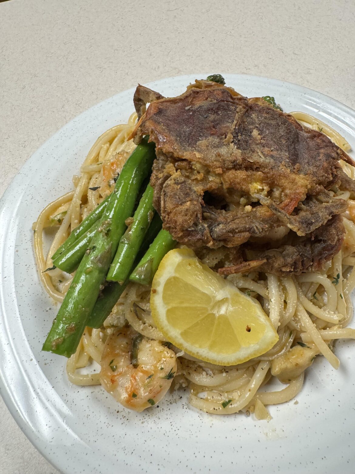 Soft shell crab over bucatini with shrimp and asparagus