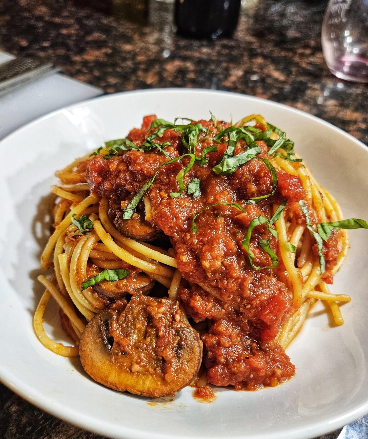 Spaghetti with mushroom ragu and fresh basil.