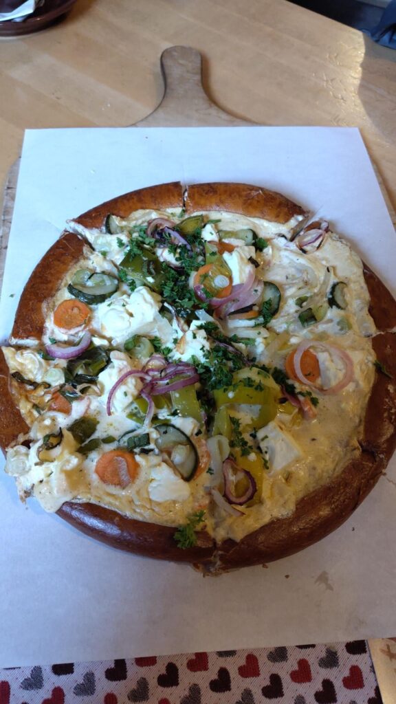 Currently eating this delicious pretzel pizza ("brizza") in Germany. Sue me.