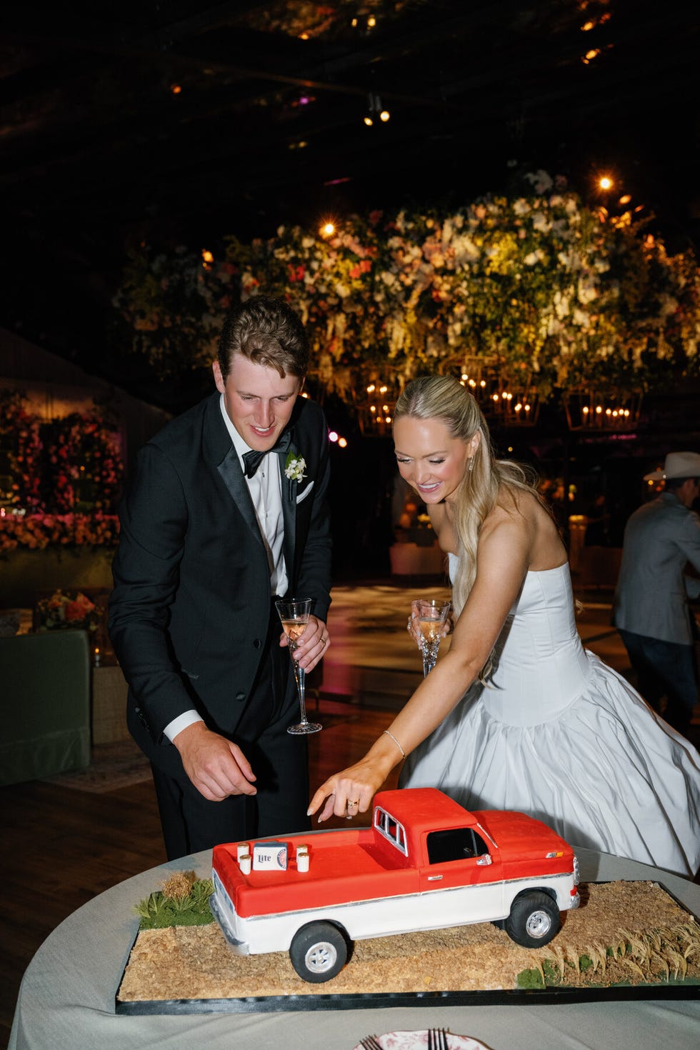 Cake designed as a vintage red and white pickup truck at an event