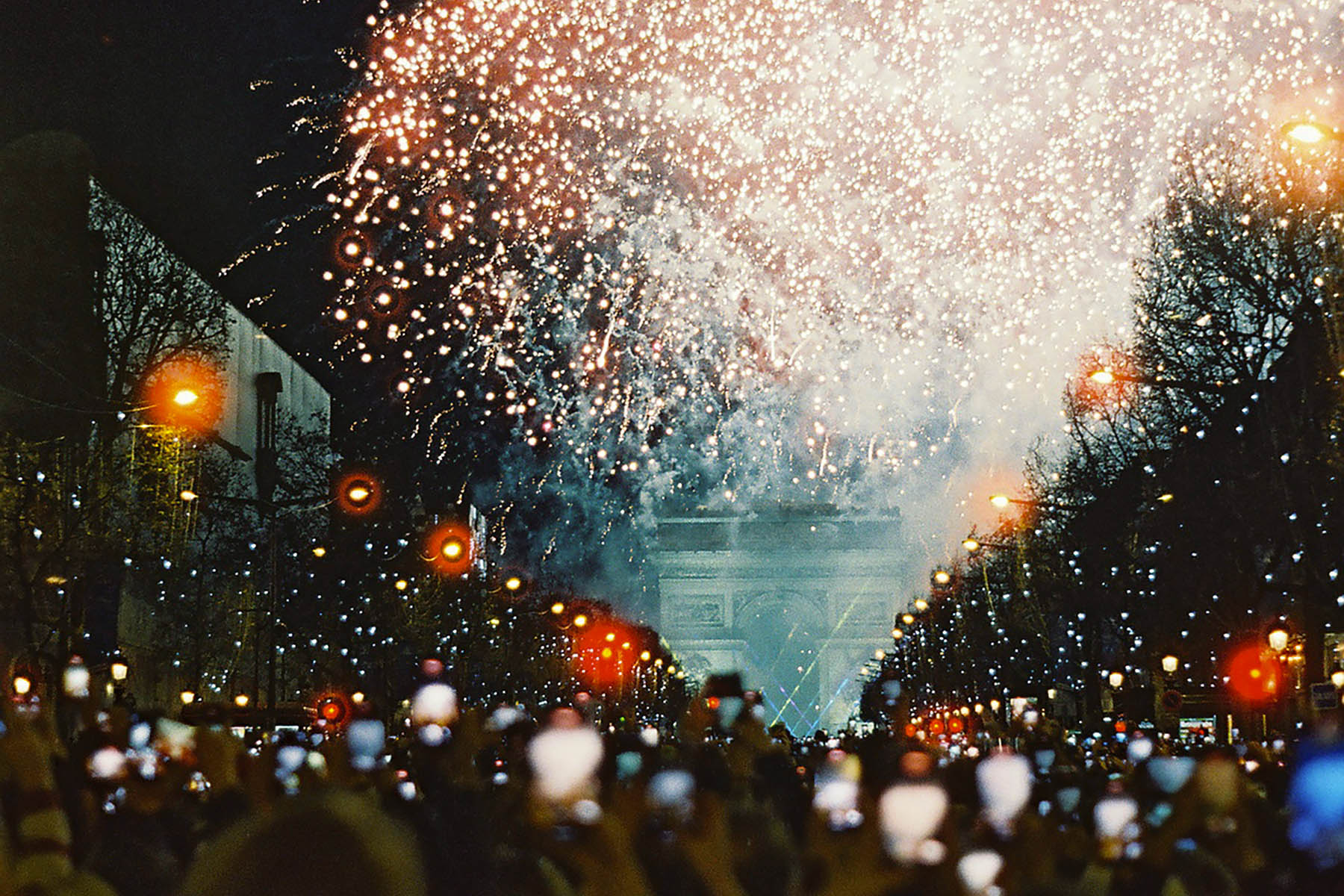 Crowd of people watching the fireworks at the Champs-Élysées in Paris, France.