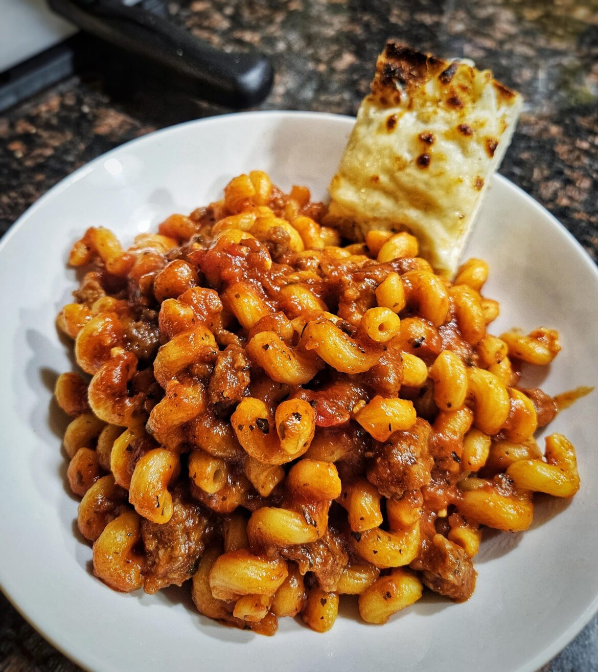 Cavatappi with sausage ragu and cheesy garlic bread.