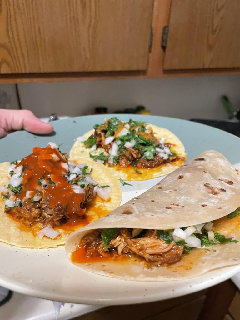 Homemade red chili braised pork shoulder tacos