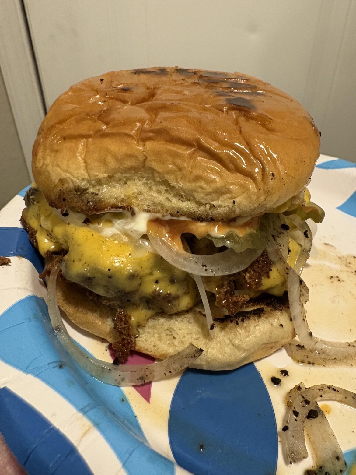Late night American burger fried in cast iron with butter