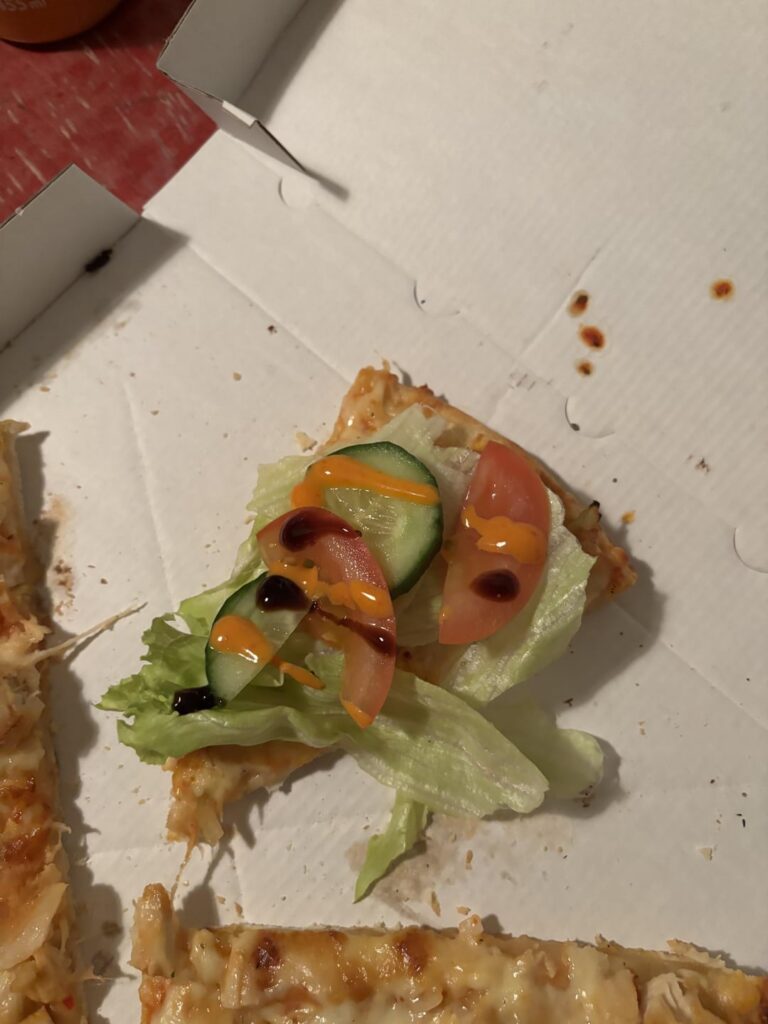 gyros pizza topped with salad, sriracha mayo and balsamic vinegar