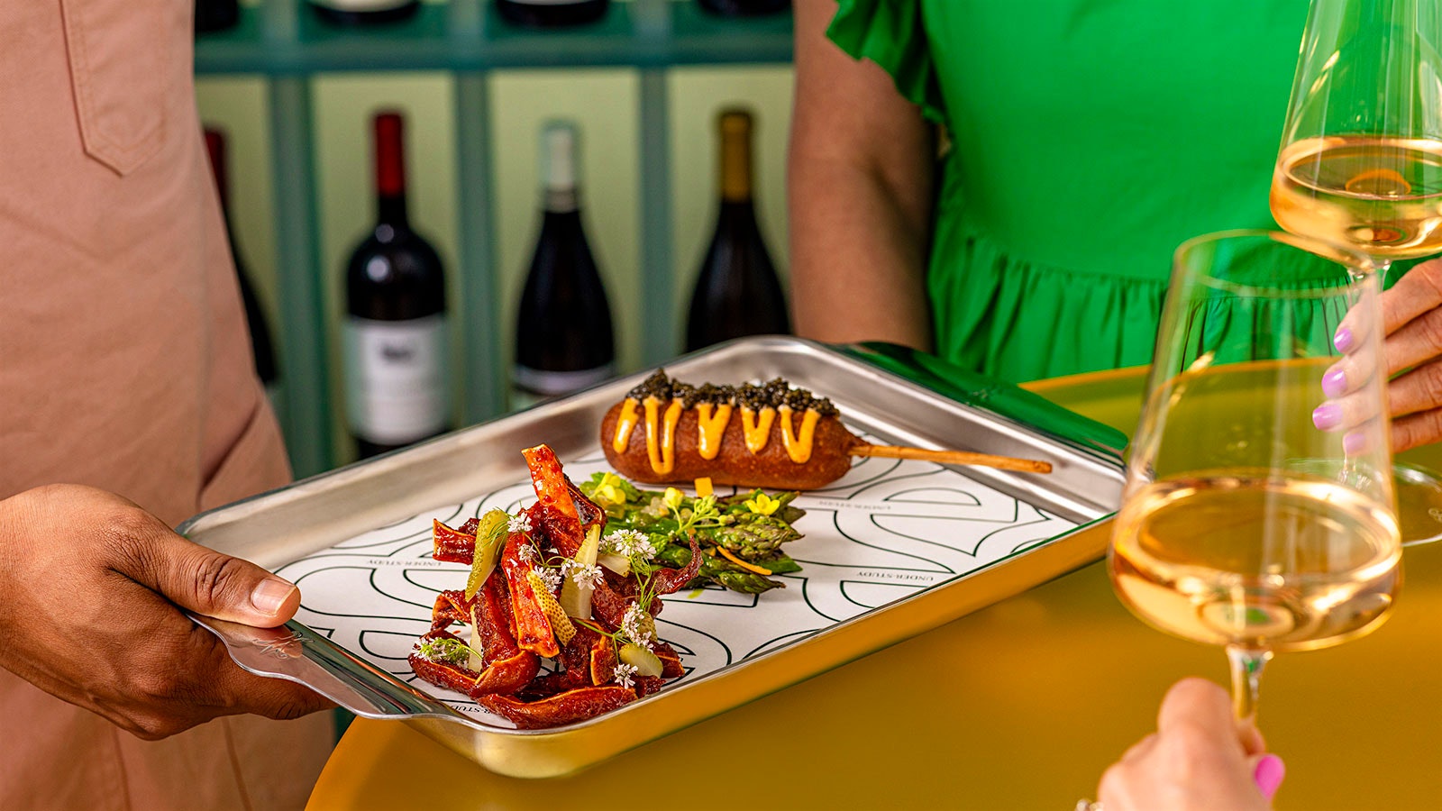 Glasses of wine and lobster corn dogs with caviar from Under-Study