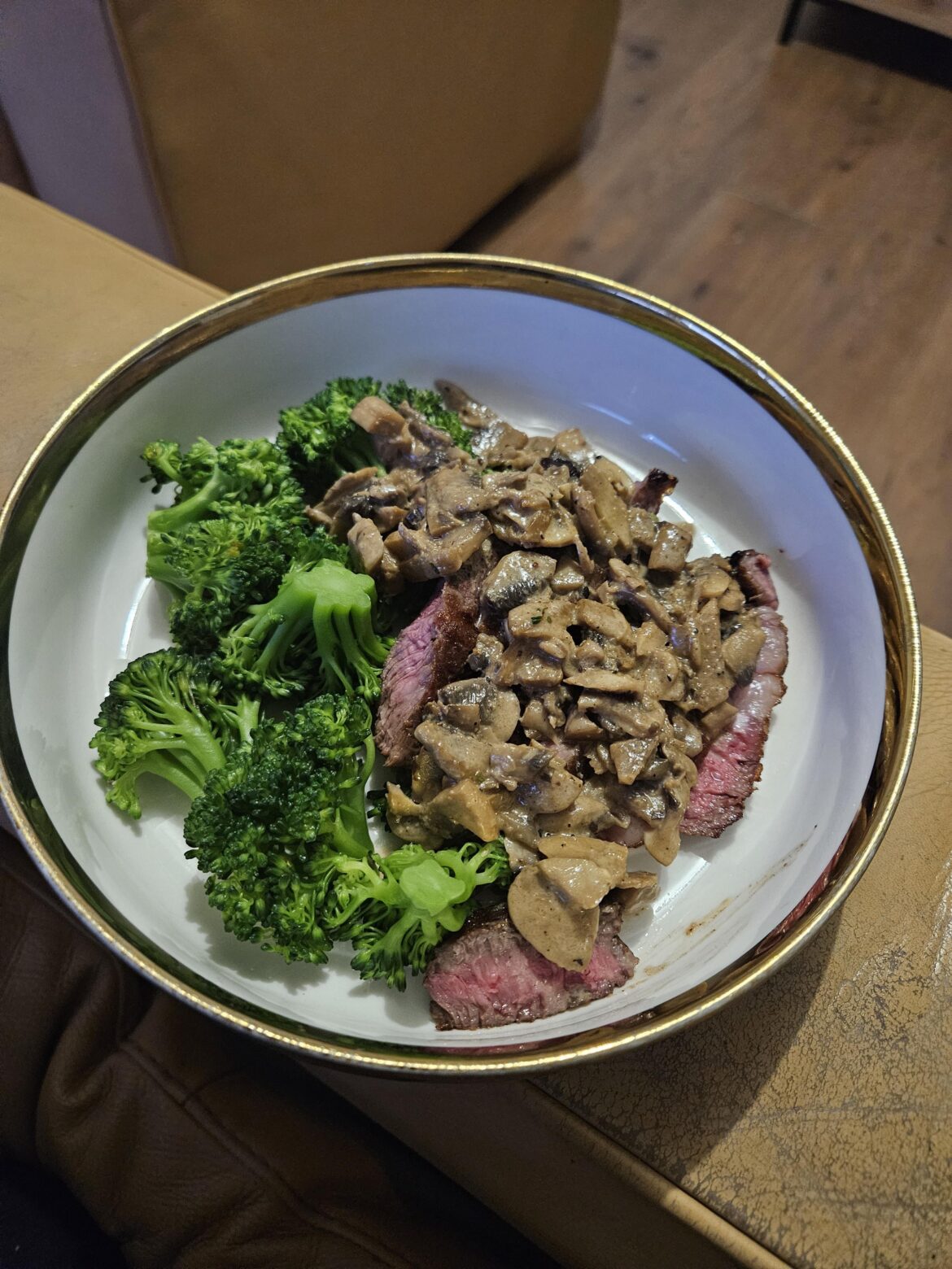 Rib eye steak with steamed broccoli and creamy mushroom sauce
