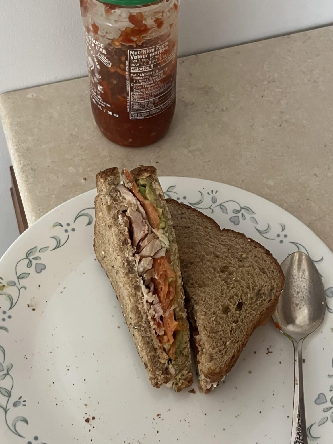 Smoked salmon, chicken, avocado, and cream cheese sandwich with chili garlic sauce