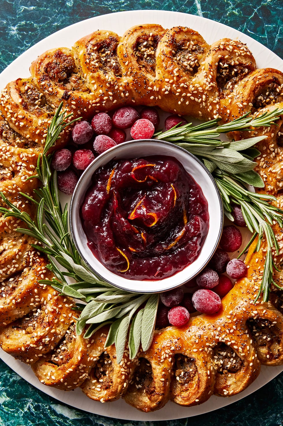 sausage roll wreath with cranberry sauce for dipping