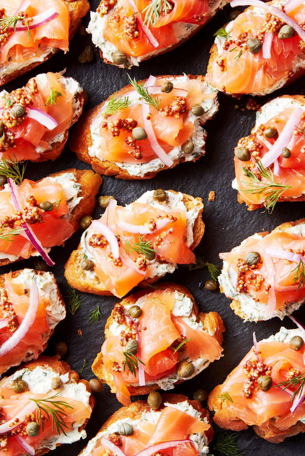 crostini topped with cream cheese, smoked salmon, red onion and capers