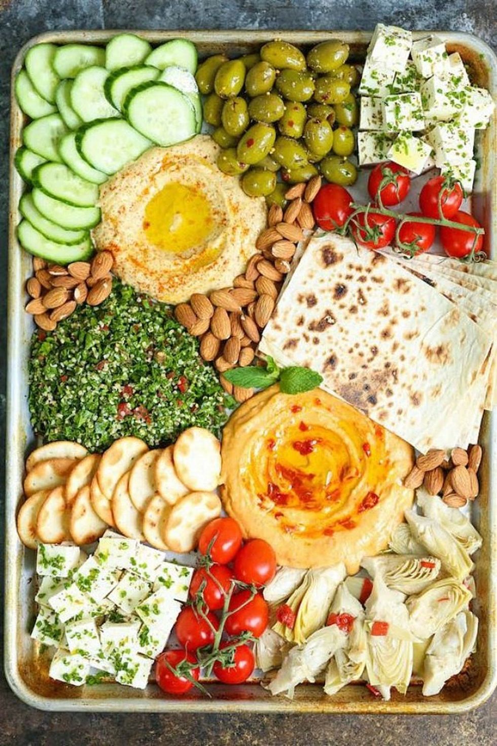 summer dinner mezze platter with cheese, tomatoes, hummus, nuts, egg