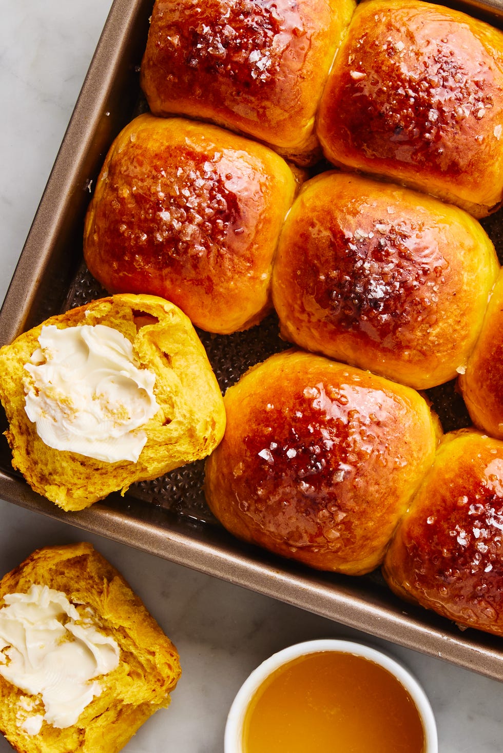 sweet potato dinner rolls brushed with butter