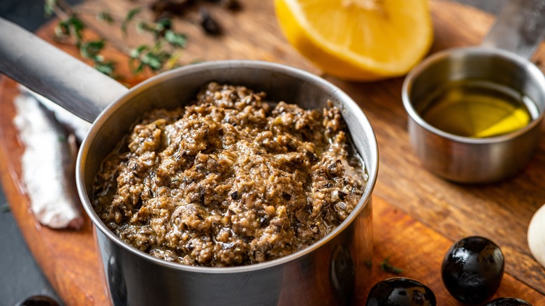 Saucepan of tapenade with oil and olives