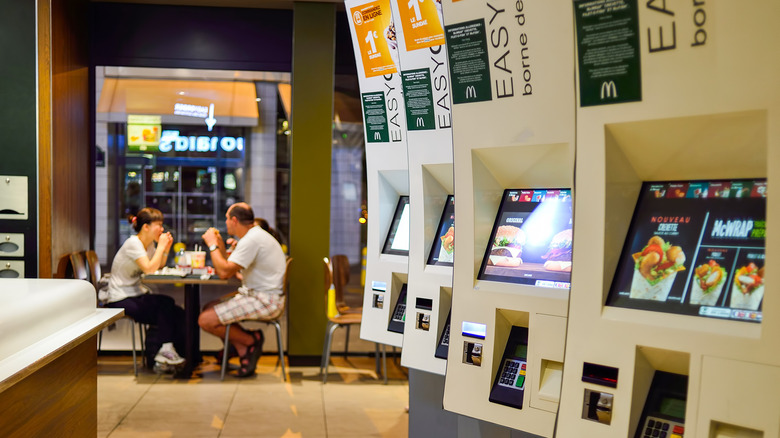 McDonalds kiosks couple eating