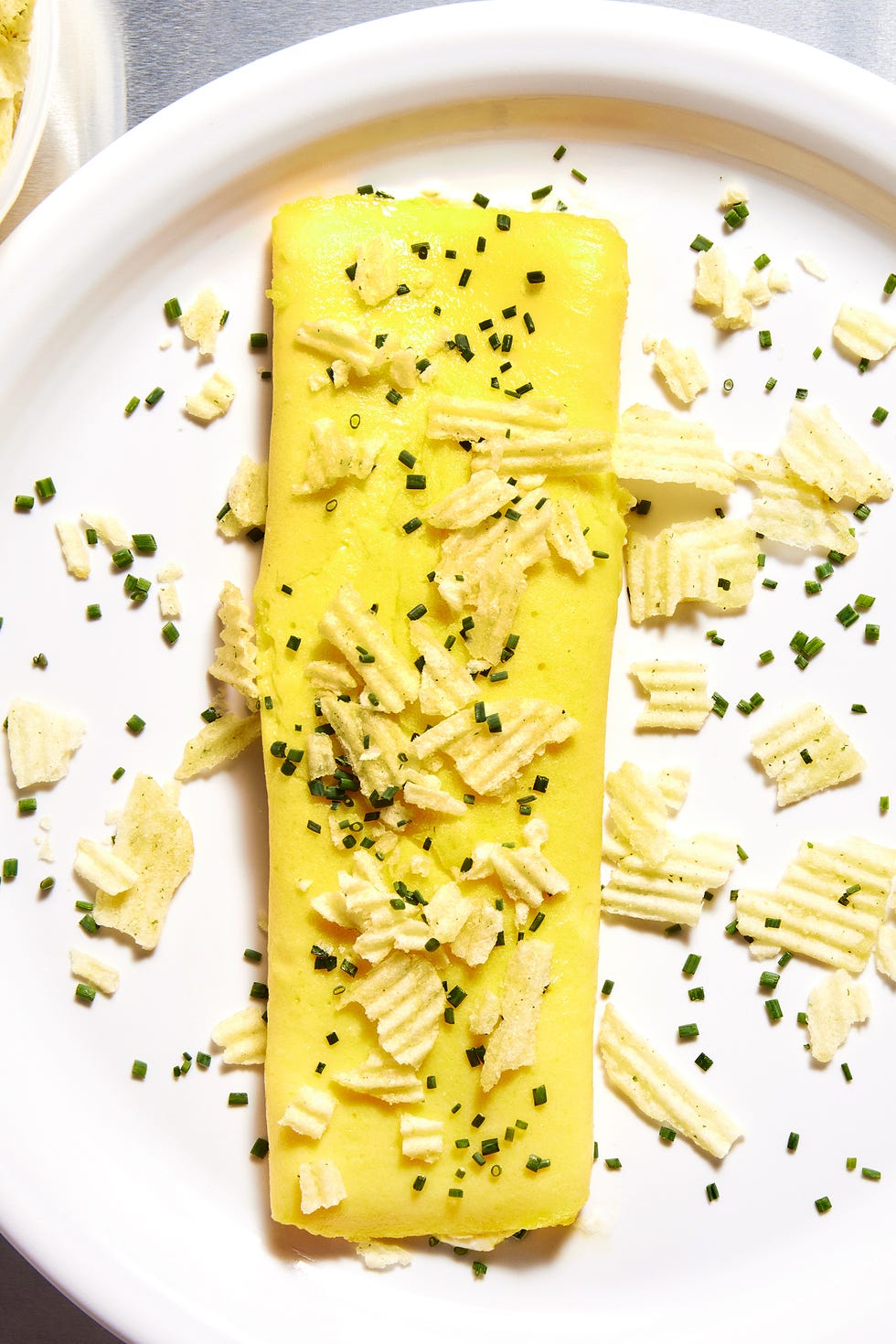boursin omelet with sour cream onion potato chips sprinkled on top with chives