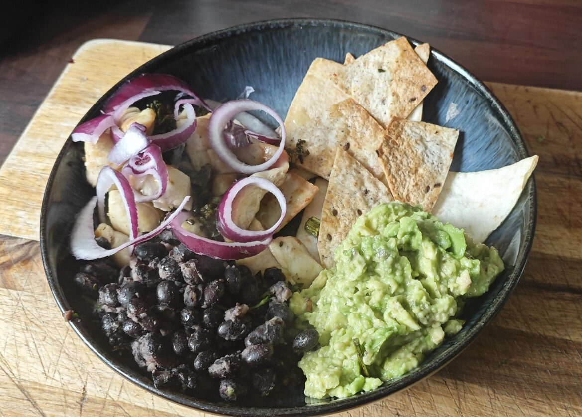 Lemon chicken, smashed avocado, fried black beans with lemon oil and coriander, baked tortillas, Mexican green sauce over chicken, red onion
