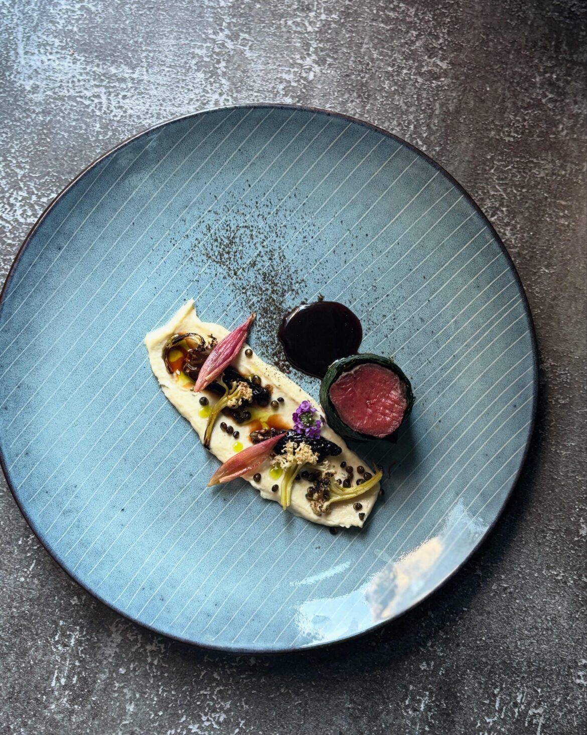 Plated a venison ballotine wrapped in wilted kale. Nordic forest.