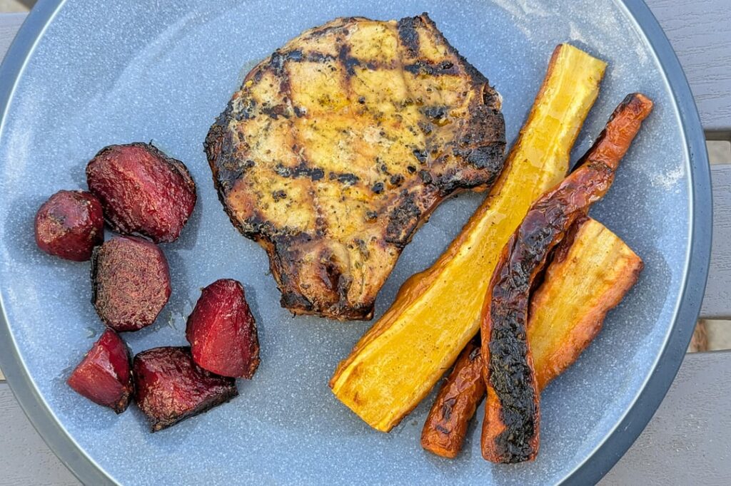 Grilled lemon herb pepper thick cut pork chop, home garden Bull's Blood beets & yellow / orange carrots