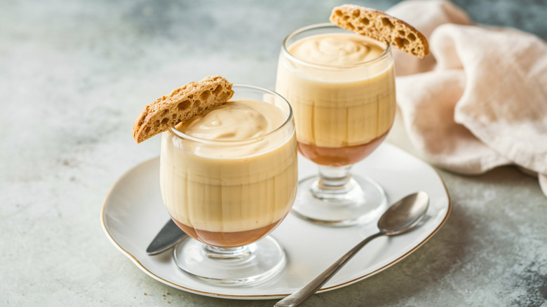 Two glass cups filled with yellow custard