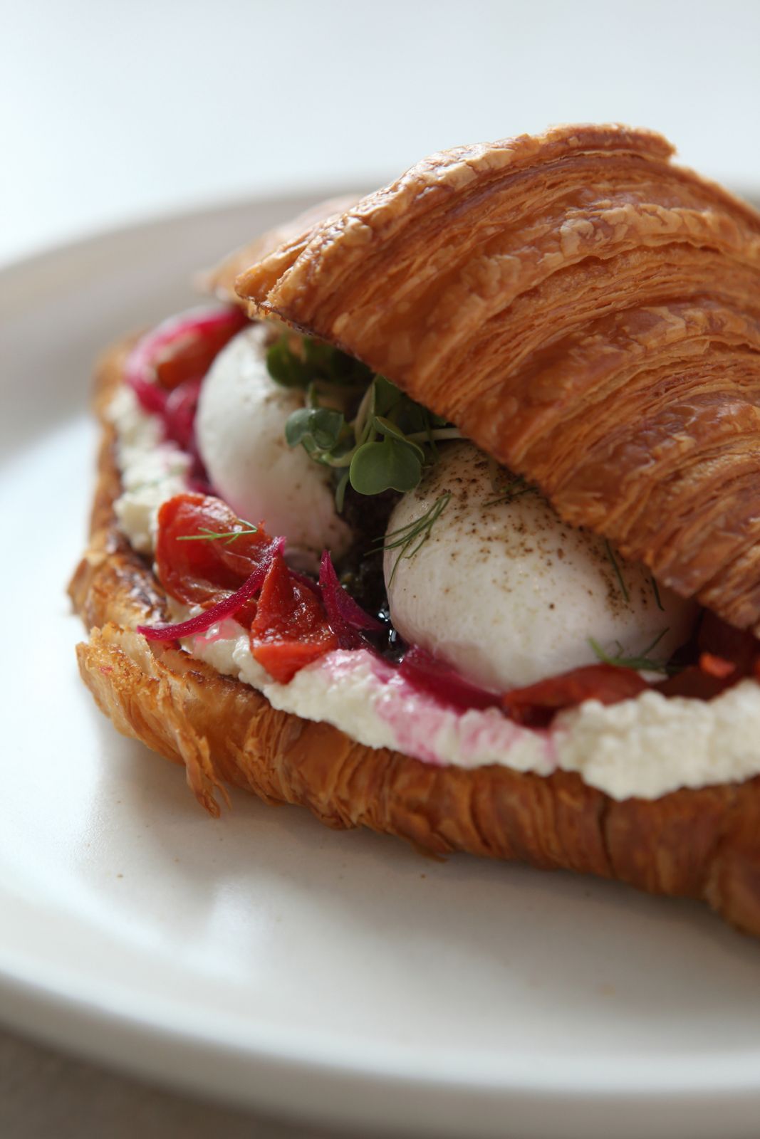 Image may contain Plate Food Food Presentation Burger Brunch Egg and Croissant