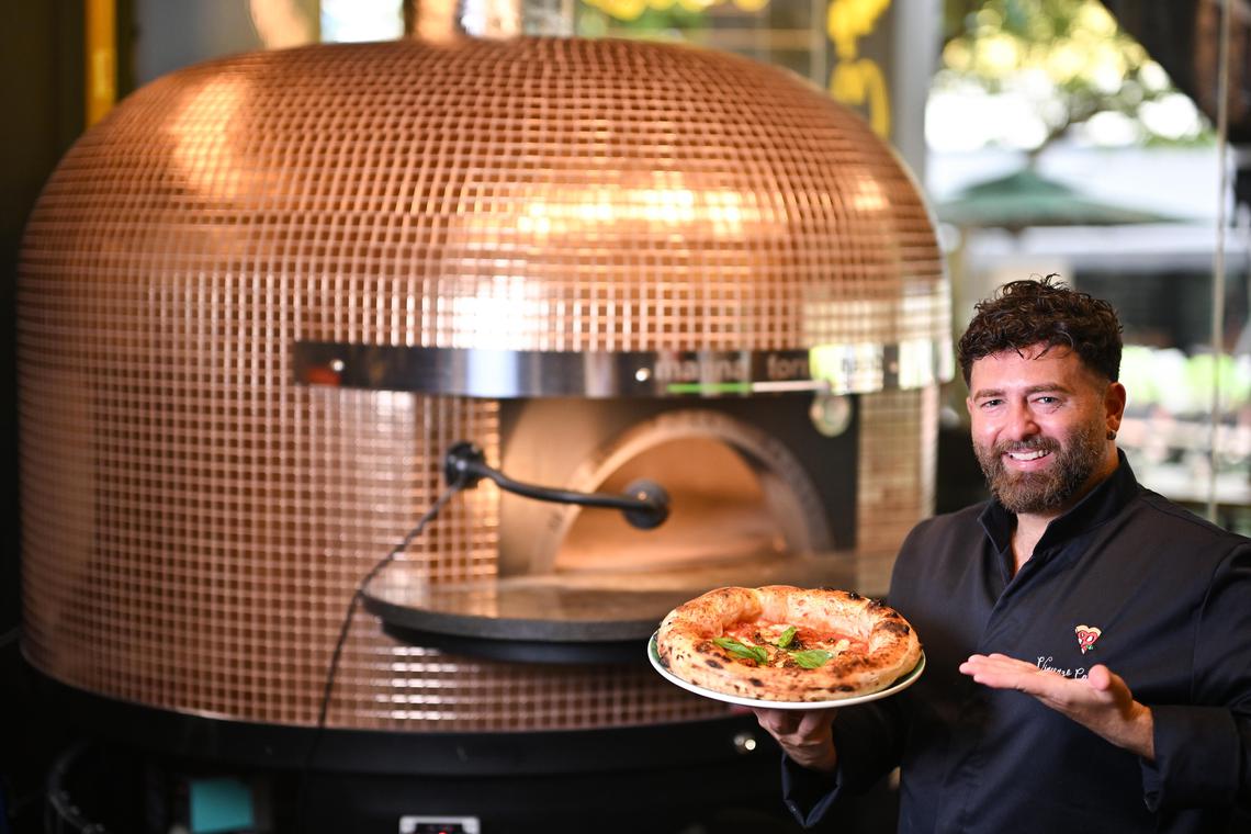 ST20250514-202506000838-Lim Yaohui-Tan Hsueh Yun-hypizza17/
Chef Vincenzo Capuano, 35, Owner and Founder of Vincenzo Capuano, holding Provola E Pepe, his world champion pizza inside his restaurant on May 14, 2025.
Feature on 2 new pizzeria brands coming to Singapore.
(ST PHOTO: LIM YAOHUI)