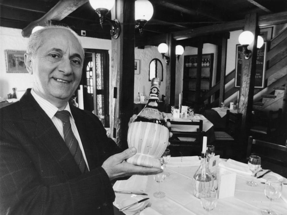 Restauranteur Tony Sanso with bottle of Italian wine in dining room of Tony's Tuscan Inn 74 Main Street, Hahndorf, SA 19 May 1994. (Pic by staff photographer Brian Webber)