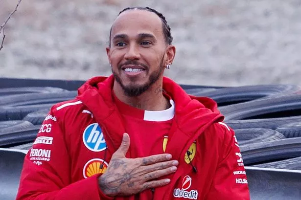 Ferrari F1 driver Lewis Hamilton gestures to fans