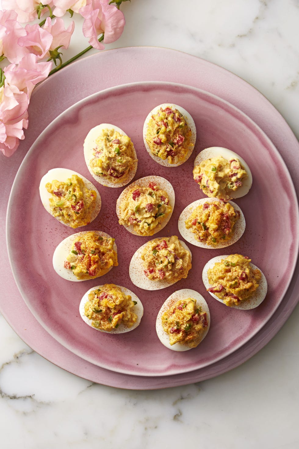 pimiento cheese deviled eggs on a pink plate