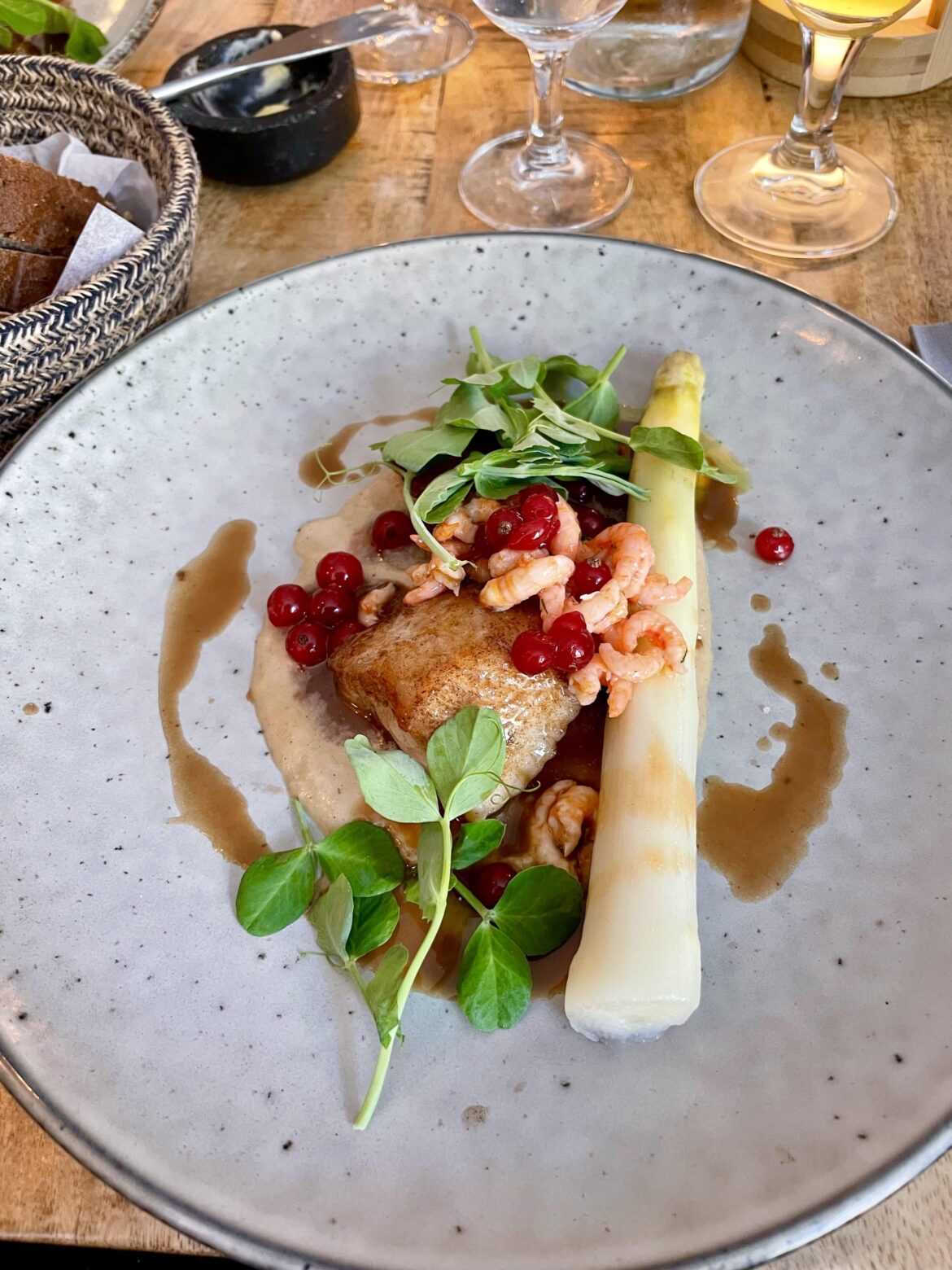 Pan-fried fish with shrimp, red currant, and asparagus in Copenhagen