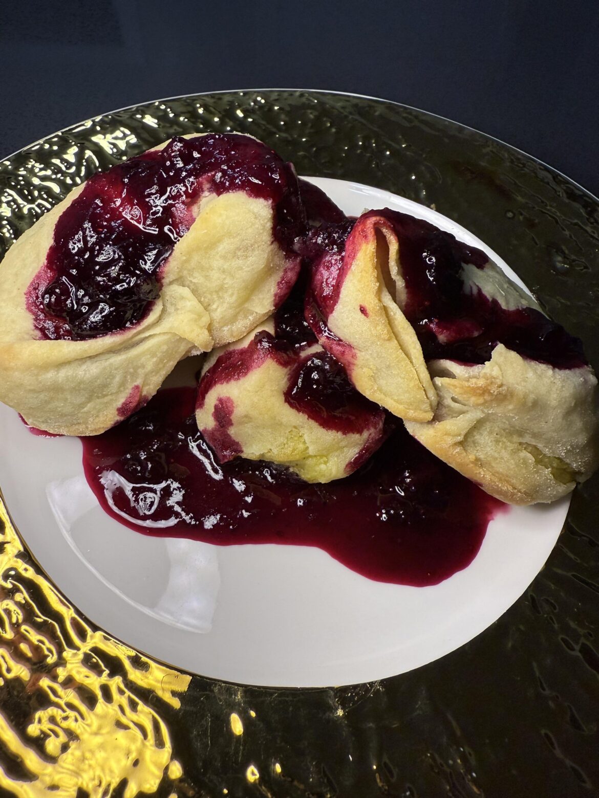 Baked Potato dumplings with blueberry sauce