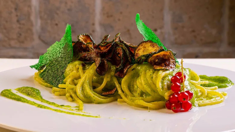 Spaghetti alla Nerano on white platter with garnish
