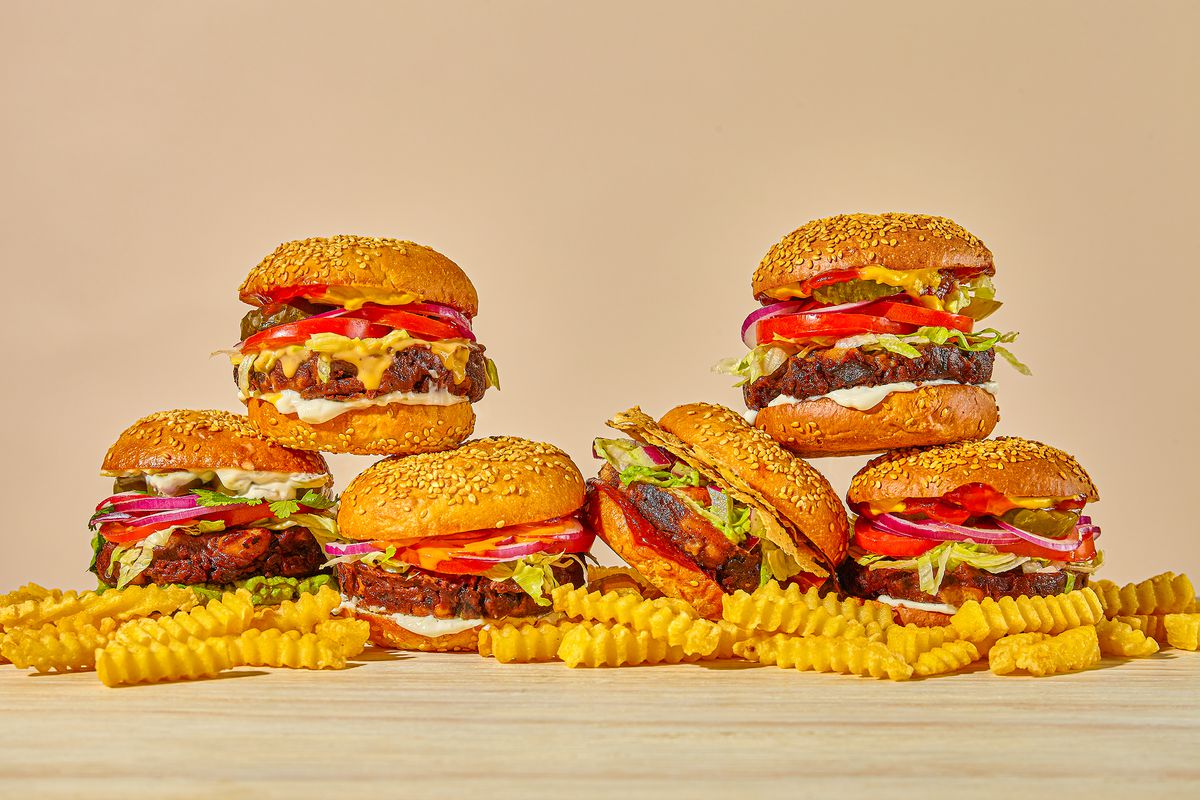 A bunch of burger places next to each other sitting on top of fries