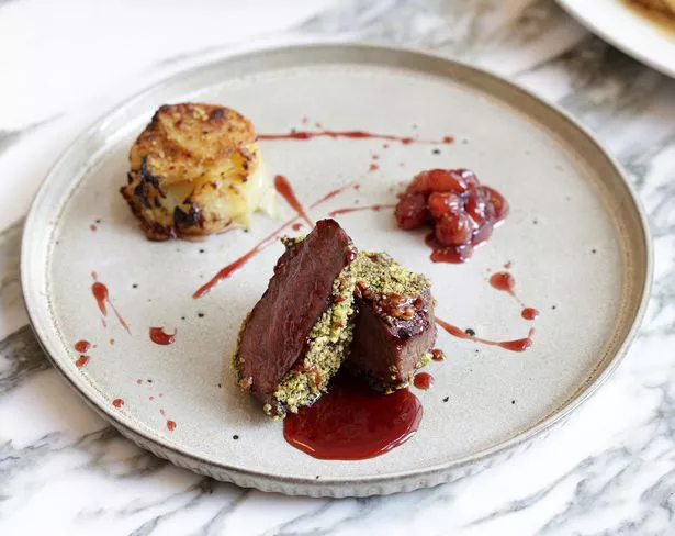Cibo's roasted lamb loin in pistachio crumb, boulangere potato, baby onion and red current jus 