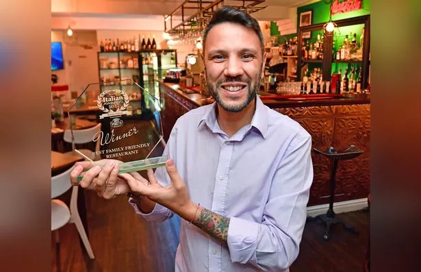 Giuseppe with the "best family-friend restaurant" award