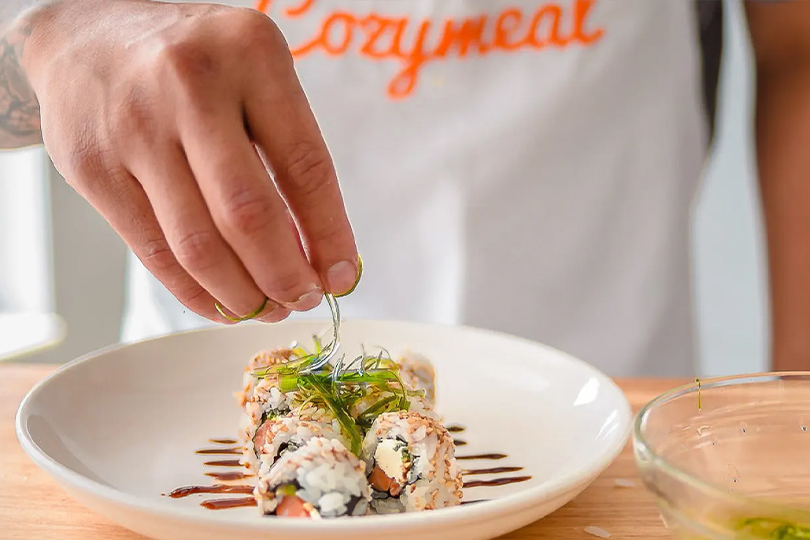 A person putting food on a plate