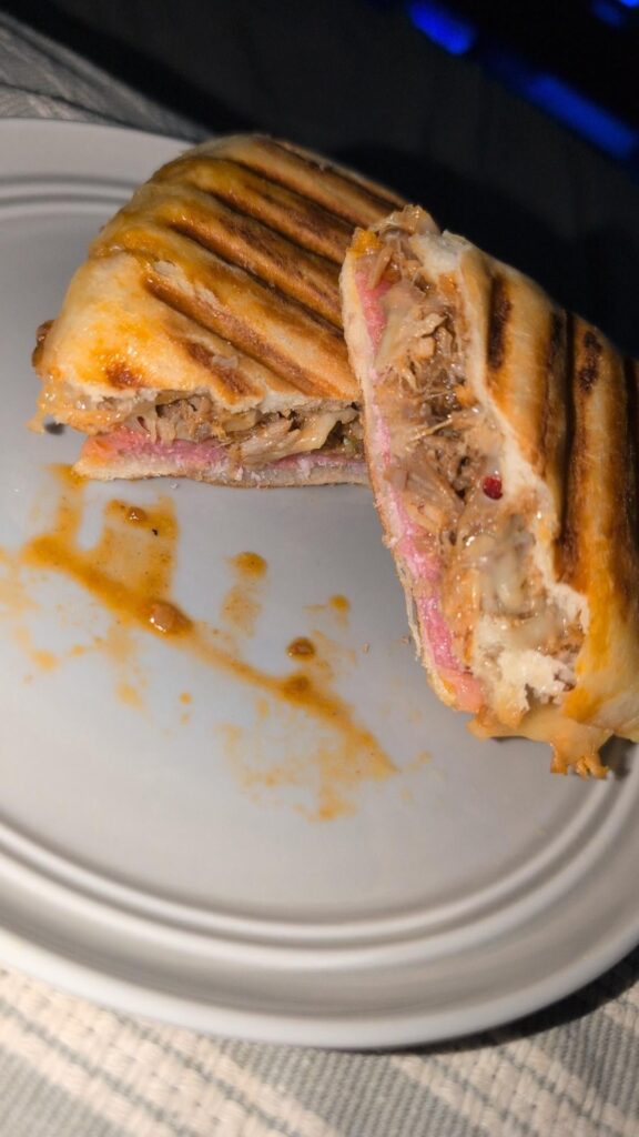 Ham, salami, pulled pork, Gouda and spring onion panini