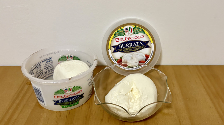 Open container of BelGioioso burrata next to serving bowl