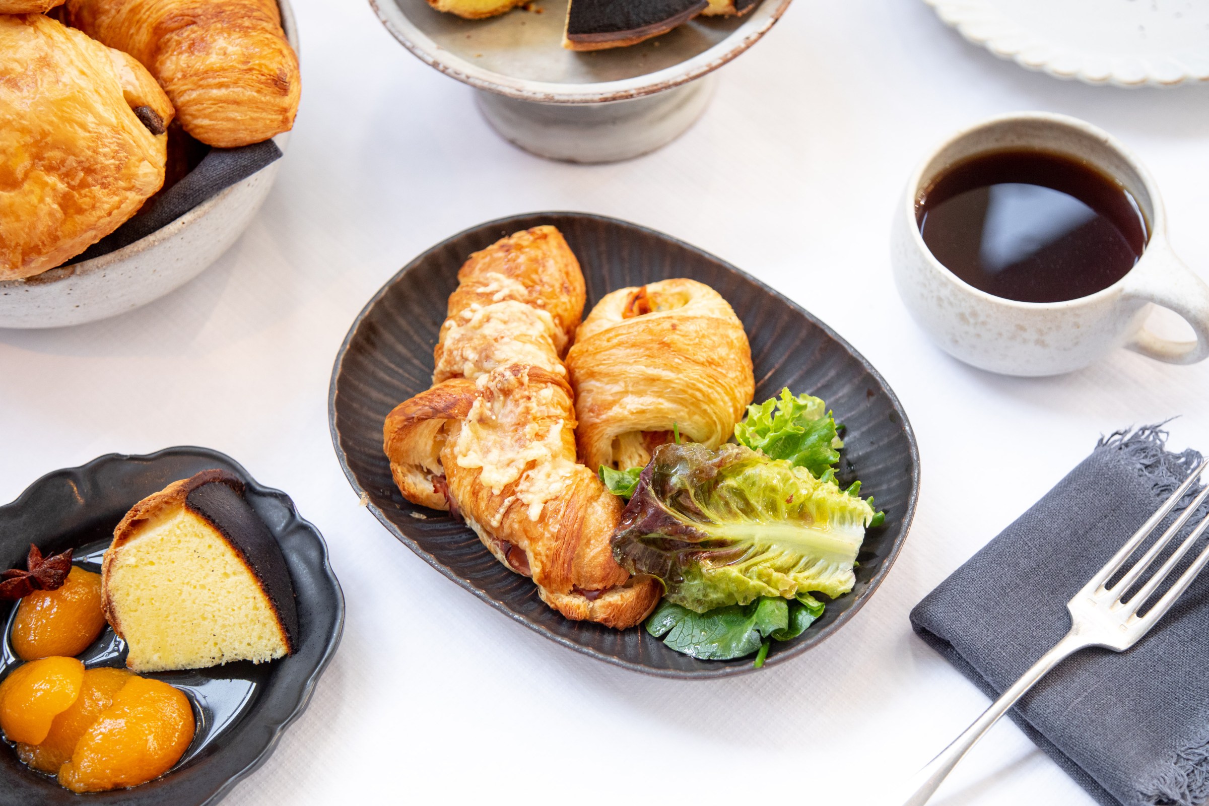 A selection of pastries, including the ham and cheese crossiant (center) and the torteau fromager (bottom left)