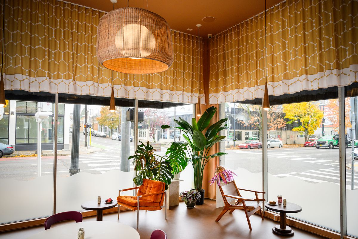 Two midcentury modern chairs sit in the window at Flour Bloom.