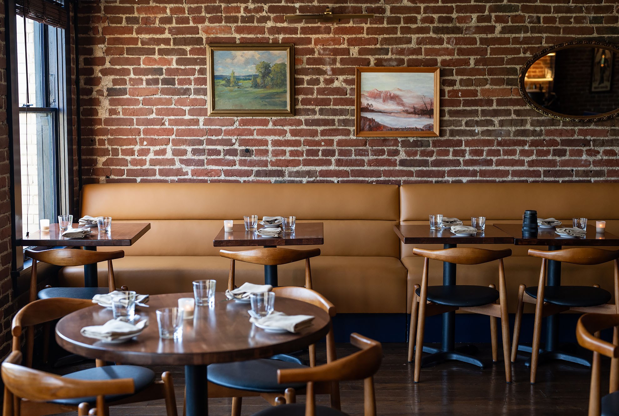 Brick walled dining room with modernist furniture.