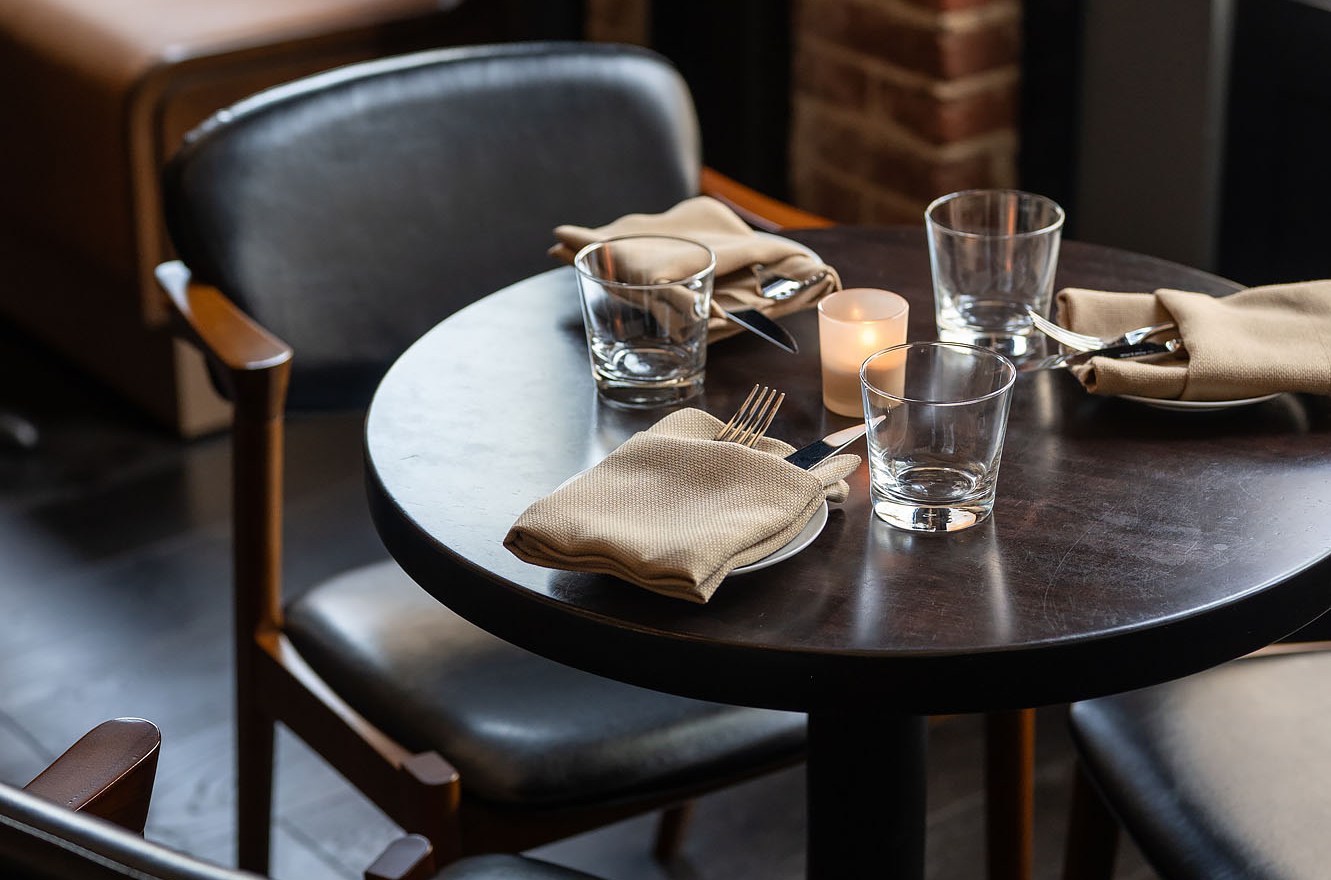 Dark wood table with leather modern chairs. 