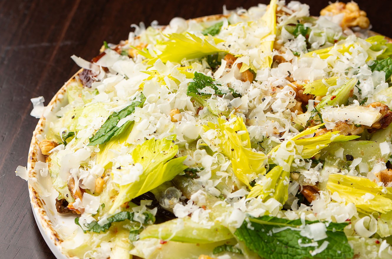 A salad of greens and shaved cheese. 