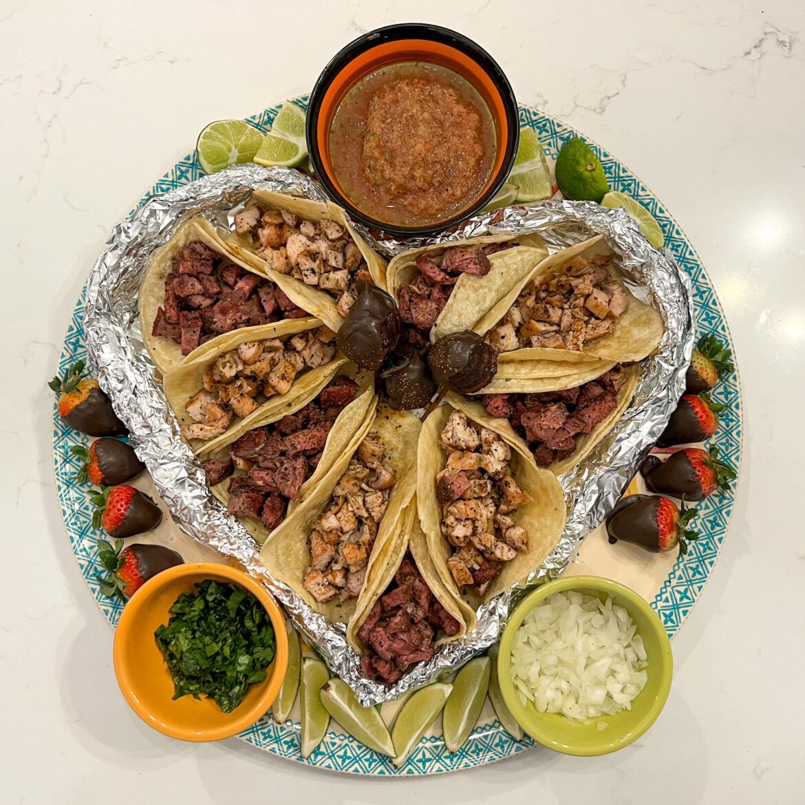 Grilled flank steak and chicken tacos we did for valentines. Also chocolate covered bacon roses tucked in the middle of the dish.